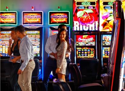 A group of people standing in front of slot machines