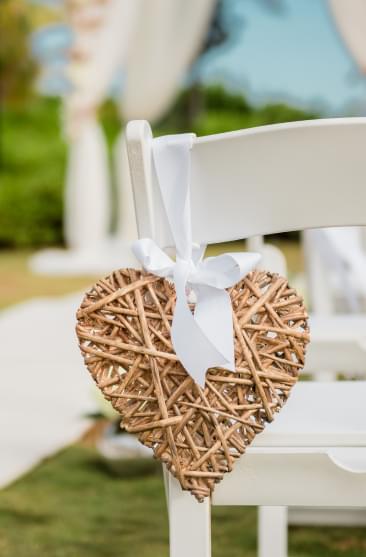 Bride and groom kissing in wedding ceremony