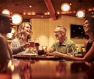 Four people with drinks at Urban Table