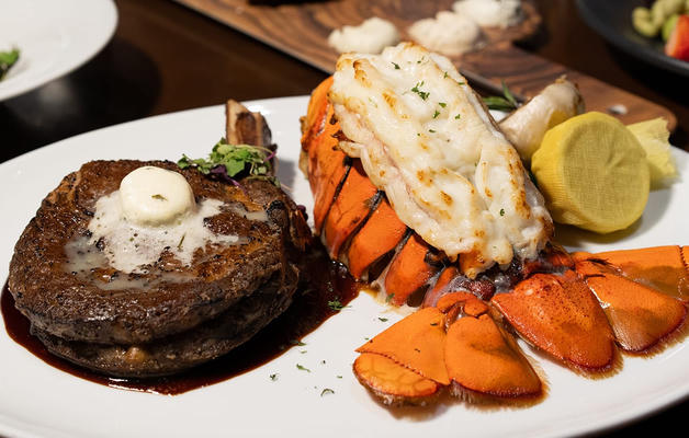 Steak and lobster dinner with lemon and butter